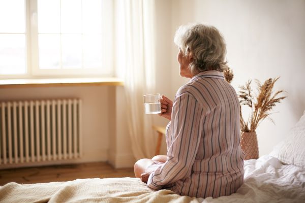 https://www.comfycentre.com/wp-content/uploads/2021/08/rear-view-senior-sixty-year-old-woman-with-gray-hair-holding-mug-washing-down-sleeping-pill-suffering-from-insomnia-elderly-retired-female-taking-medicine-with-water-sitting-bedroom.jpg